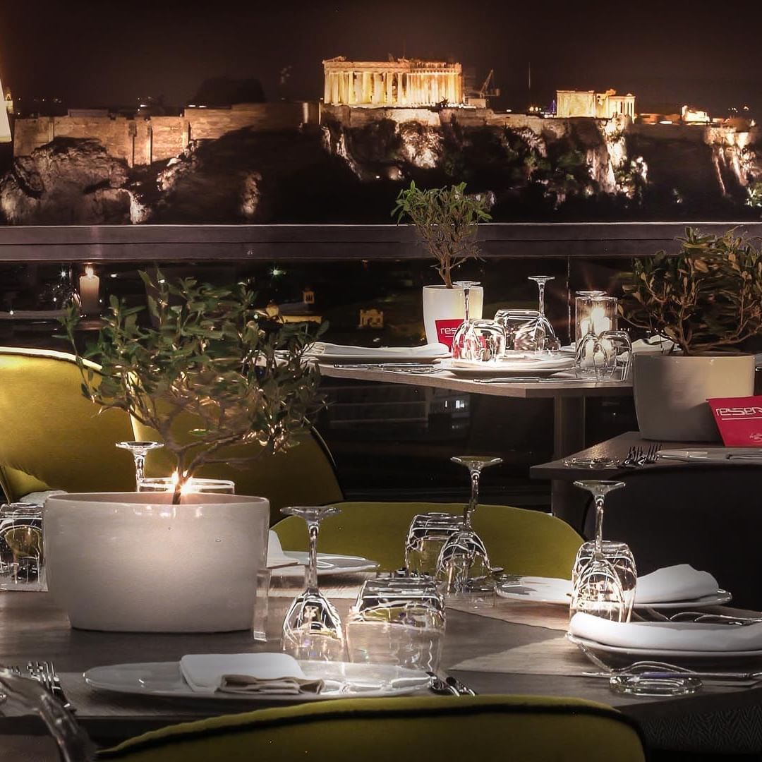 Arranged dine area by night city view at St George Lycabettus 
