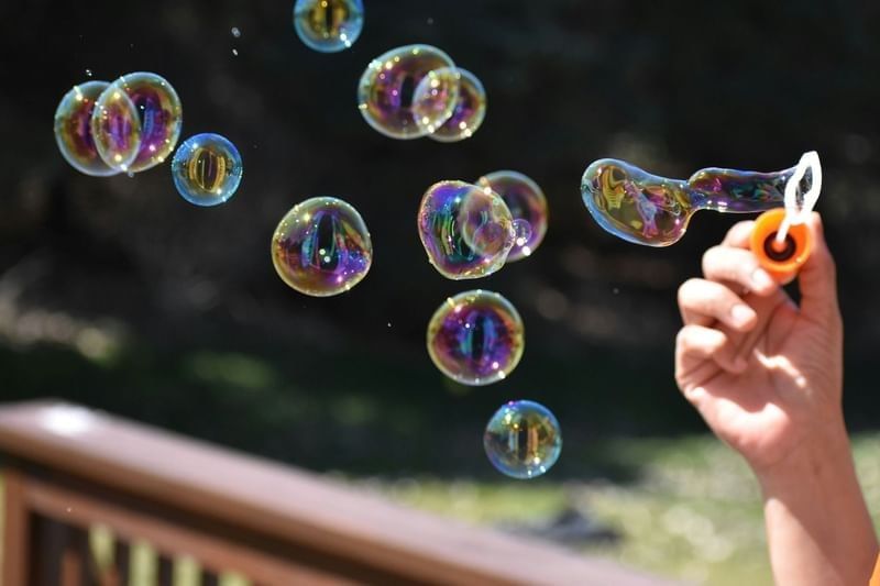 Colorful soap bubbles floating in the air outdoors on a bright and sunny afternoon at Shangri-La Resort and Golf Club