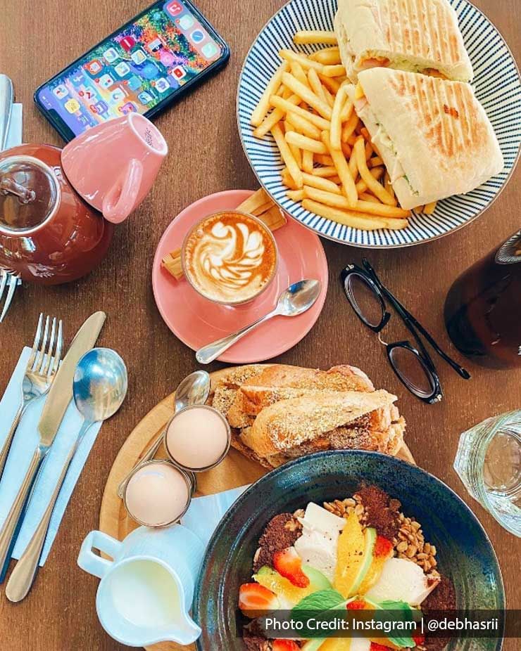 Top view of a club sandwich & latte served in a Restaurant near Imperial Lexis, best Malaysian Restaurants Kuala Lumpur