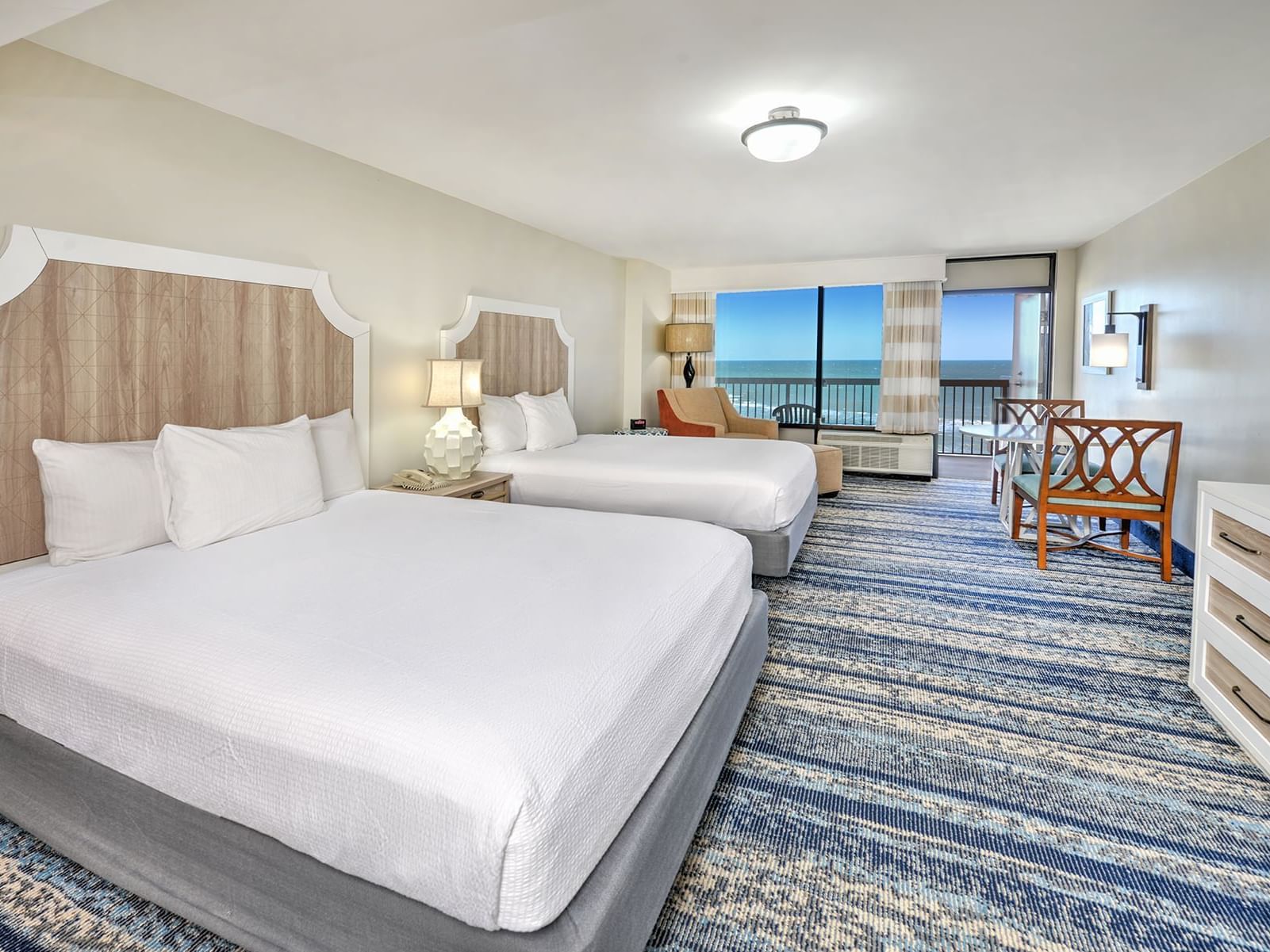 Ocean View Suite Kitchenette at Bahama House in Daytona Beach with two beds and balcony.