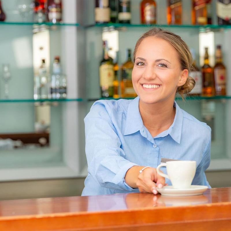 Female bartender serving at Falkensteiner Hotels & Residences