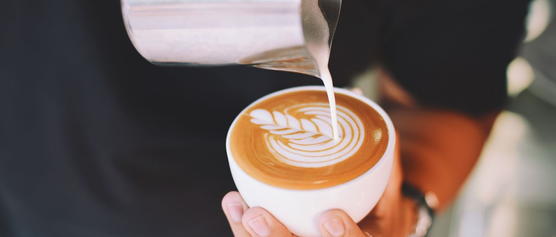 A chef making art on a latte at Commodore Restaurant & Café