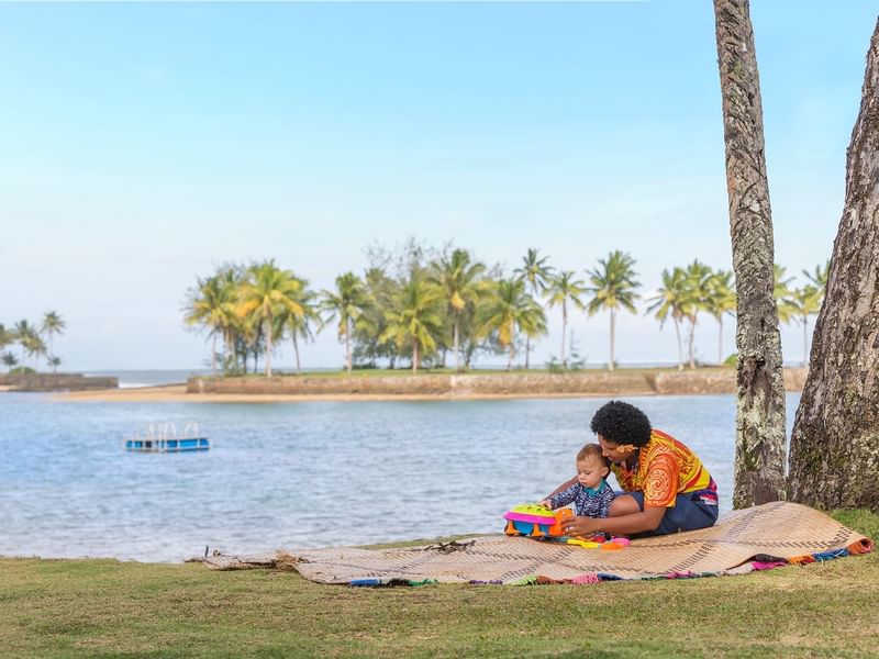 A woman babysitting with a sea view at The Naviti Resort