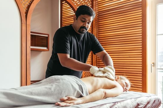 Lady receiving a body massage in the spa at Liebes Rot Flueh