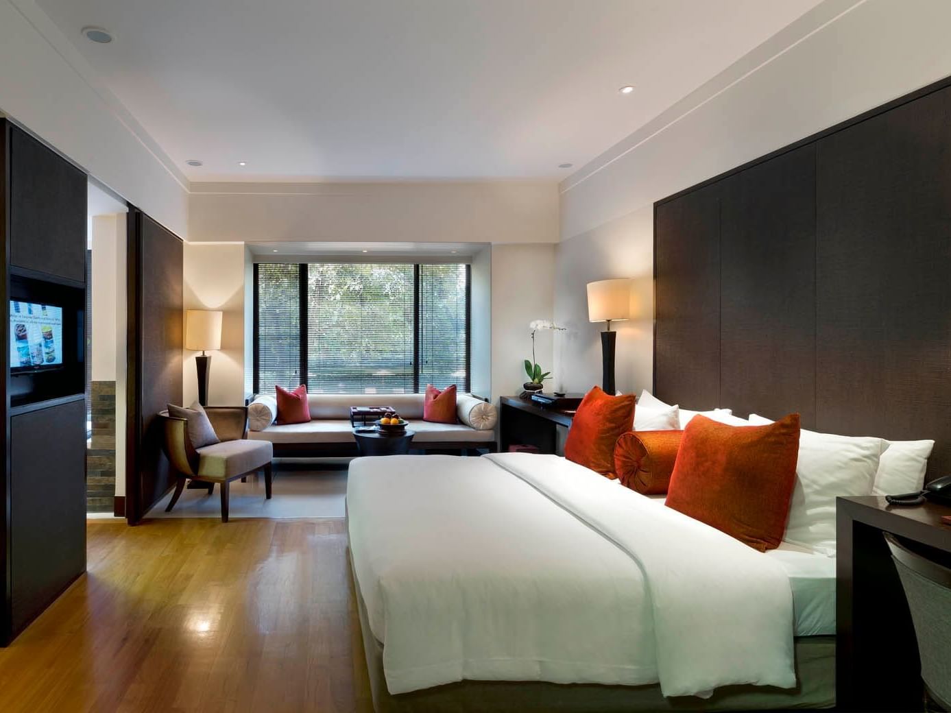 Interior of the Club Room with a window lounge and TV by the King bed at Saujana Hotel Kuala Lumpur
