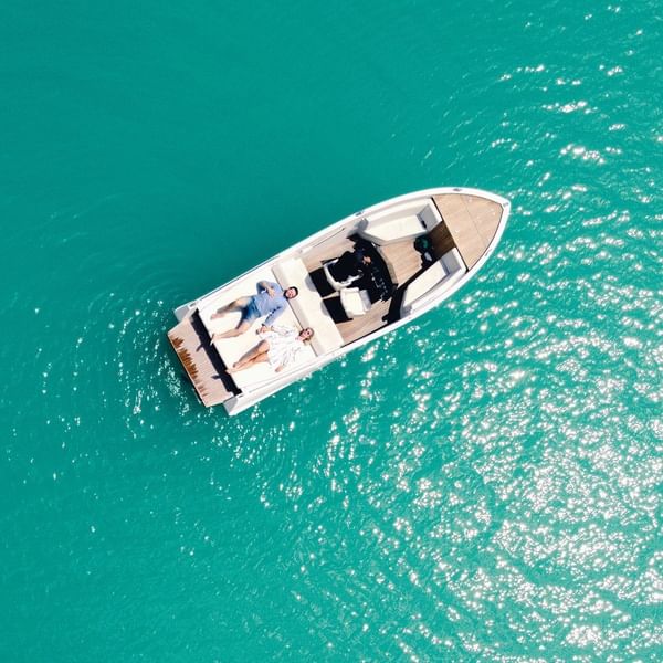 High angle view of a couple relaxing on a boat at sea near Falkensteiner Schlosshotel Velden