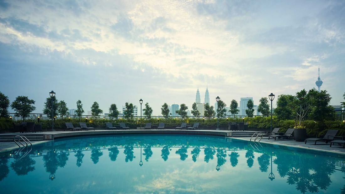 Exterior view of hotel pool with sunbeds at Sunway Putra Hotel