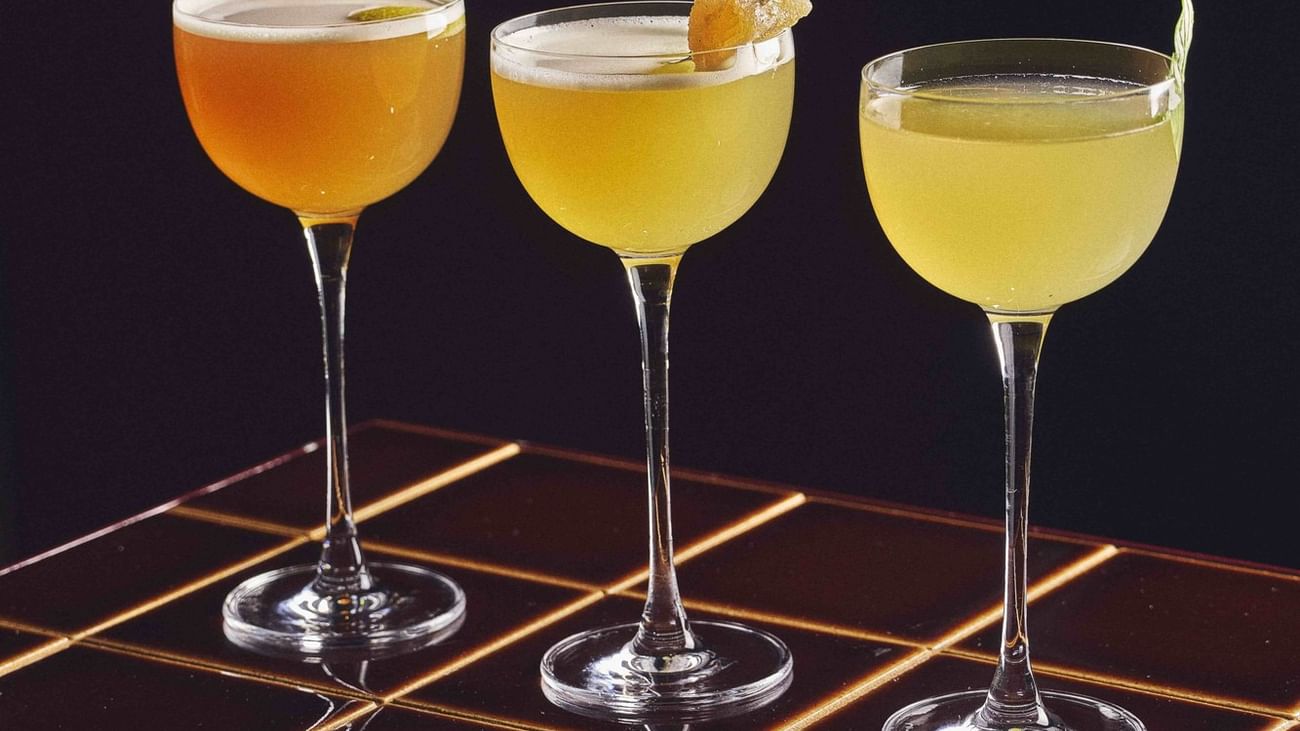 Three glasses of cocktails with garnishes at Sofitel Sydney Wentworth in Sydney.