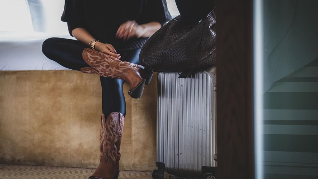 Close up on a girl lacing up boots at The May Fair Hotel London