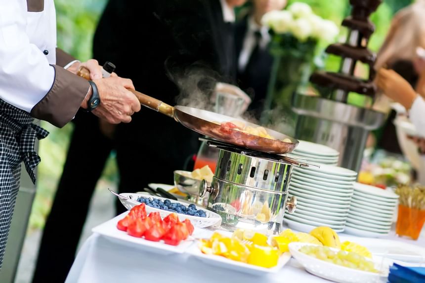 Close-up of chef cooking on a wedding at 2 Seasons Hotel & Apt