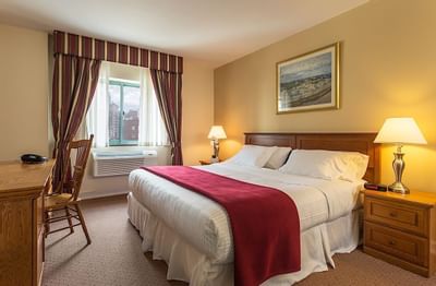 King bed & work desk in King Room at Chelsea Savoy Hotel