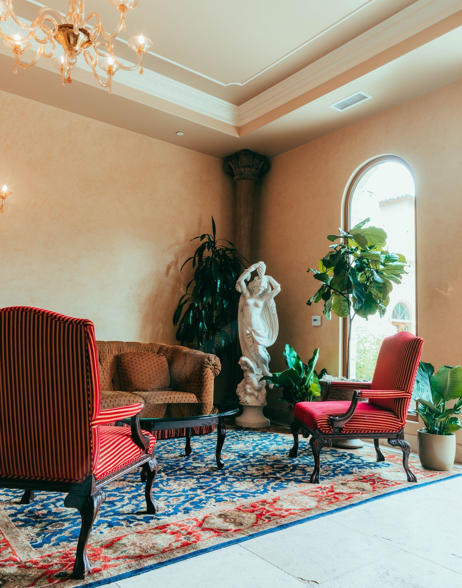 Lorem ipsum Sitting area with two red arm chairs and brown sofa