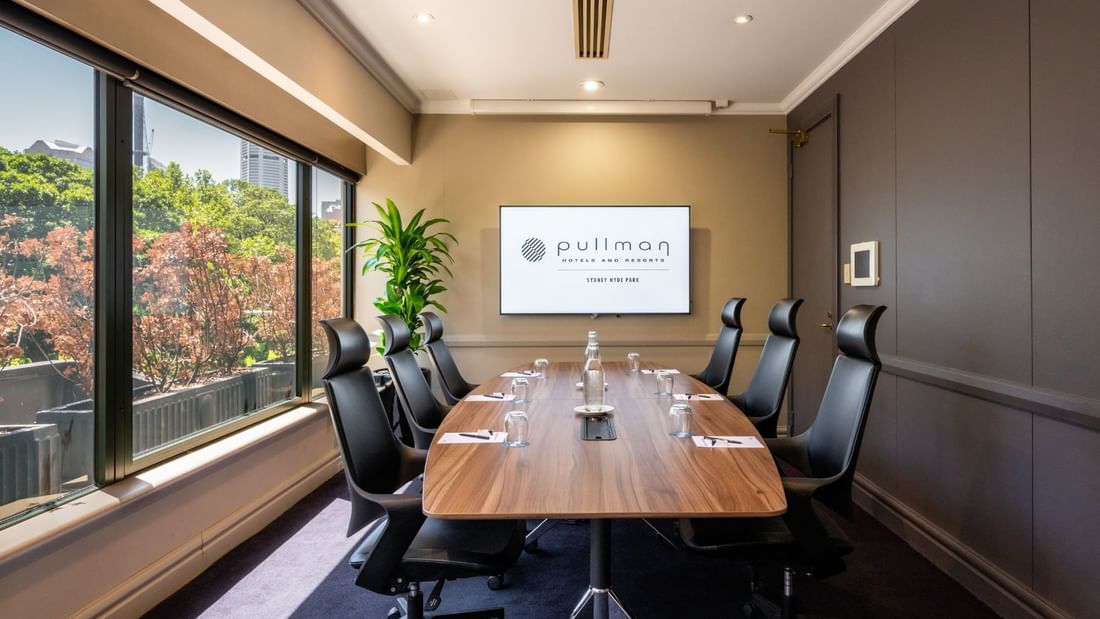 Boardroom set-up with TV in Busby Room at Pullman Sydney Hyde Park