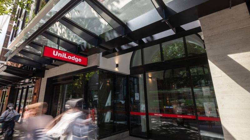 Blurry pedestrians pass by UniLodge Melbourne Central on La Trobe Street.