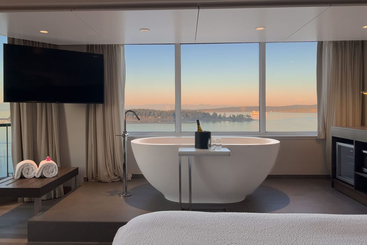 Hotel guestroom with soaker tub in front of a window