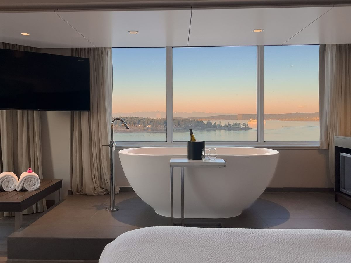 Hotel guestroom with soaker tub in front of a window