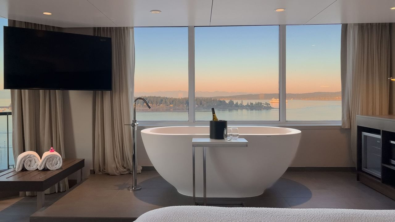 Hotel guestroom with soaker tub in front of a window