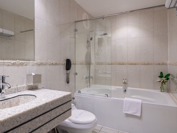 Bathroom with a bathtub and vanity area at Warwick Hotel Al Jubail