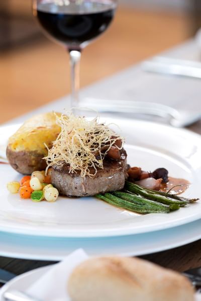 well plated steak dish with some wine at NOI Blend Colchagua