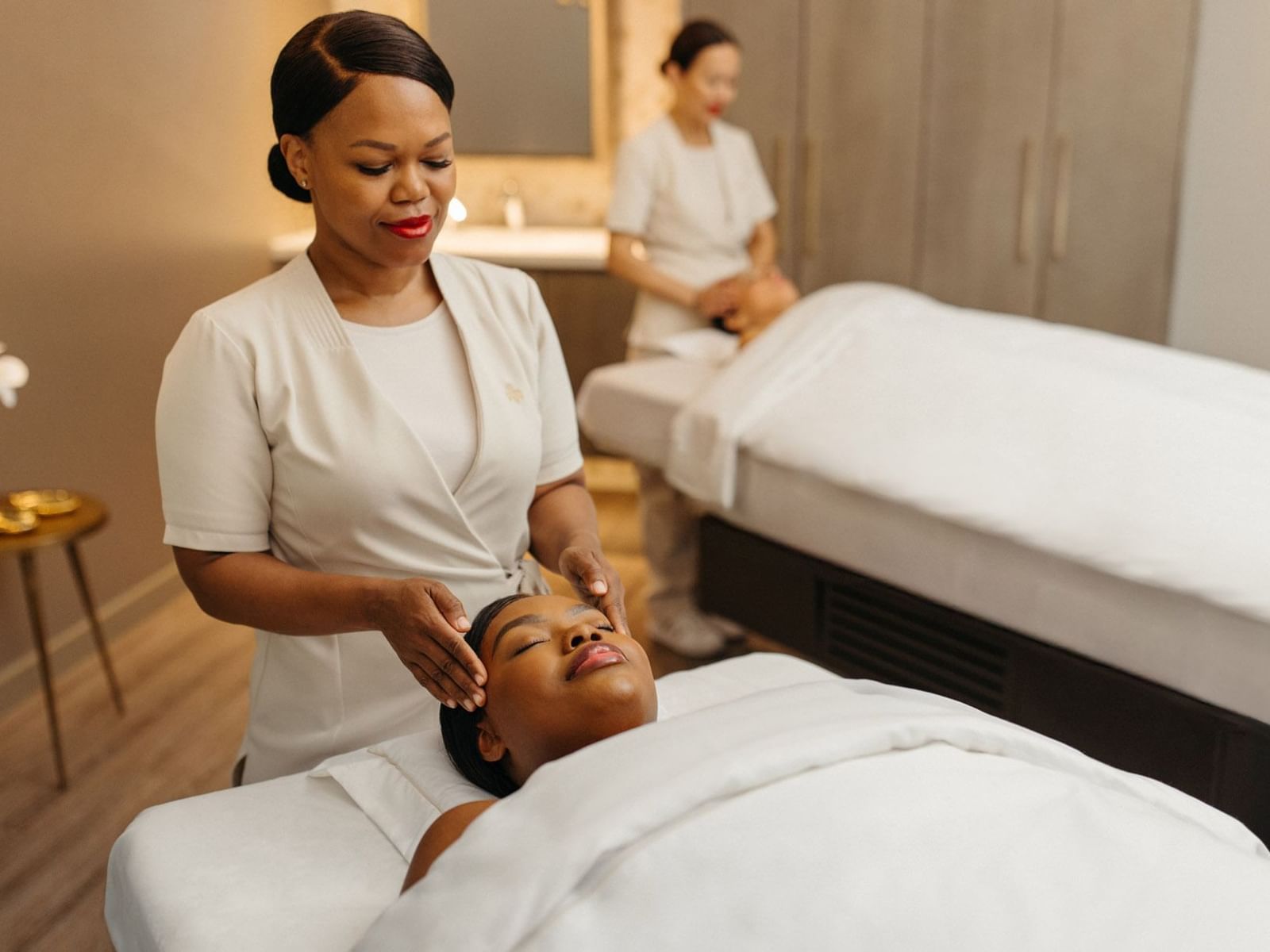 Spa setting with two massage therapists and beds at Hotel X Toronto, a hotel and Spa Toronto