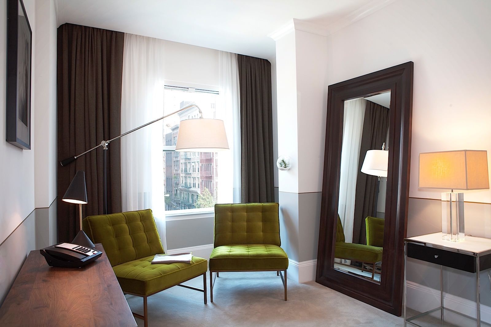 Junior Suite sitting area with large mirror and window 