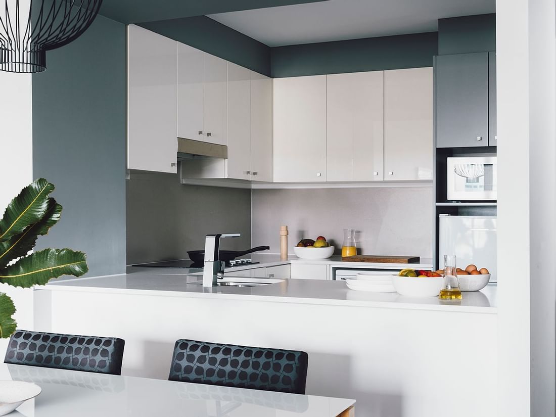 Kitchen & dining area in 2 Bedroom 2 Bathroom Deluxe Apartment with City & River Views at Quay West Suites Melbourne
