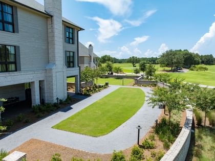 Spacious ANR Lawn with manicured green space, paved pathways, and landscaped gardens at Camp Creek Inn in Inlet Beach.