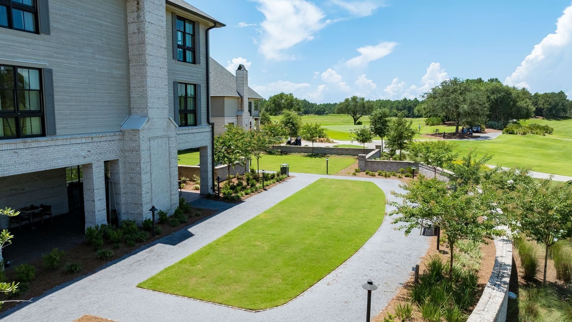 Spacious ANR Lawn with manicured green space, paved pathways, and landscaped gardens at Camp Creek Inn in Inlet Beach.