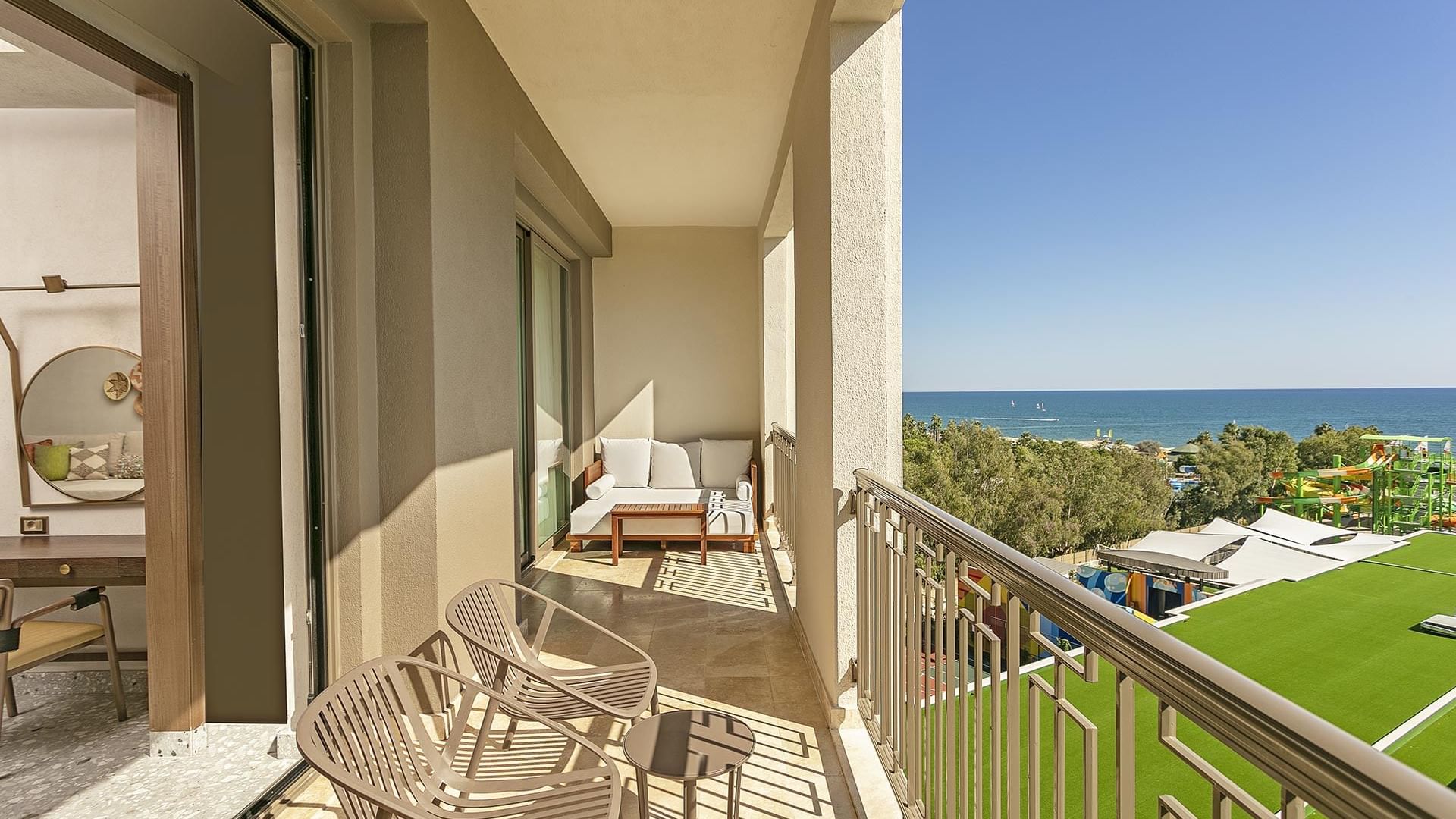 Golf course & ocean view from balcony with two chairs & sofa in Grand Family at Cullinan Belek