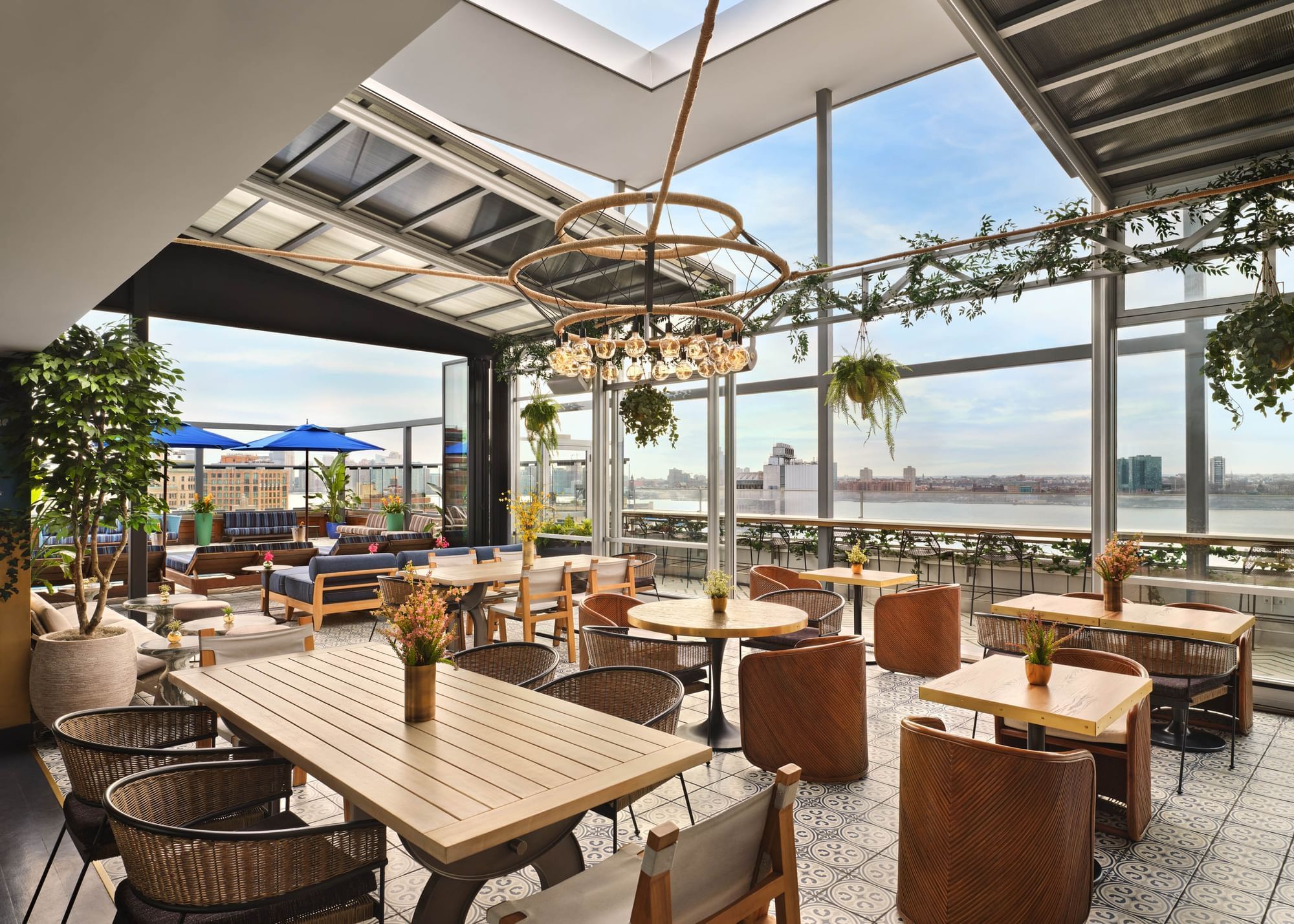 Rooftop with chairs and tables showcasing the Hudson river virews