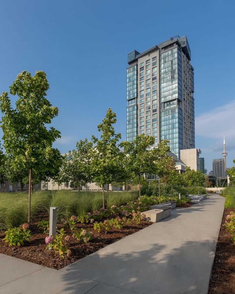 Hotel X surrounded by landscaped gardens and walking paths
