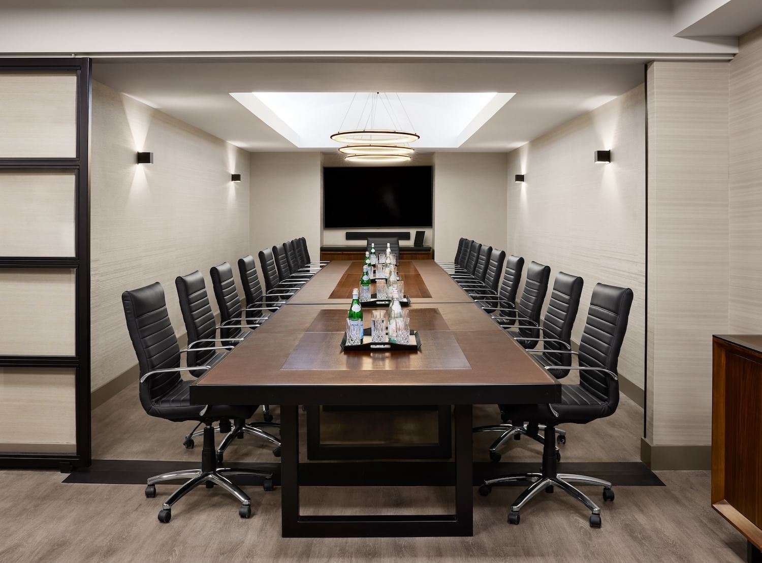 A conference room with a long table and chairs at Gansevoort Meatpacking NYC