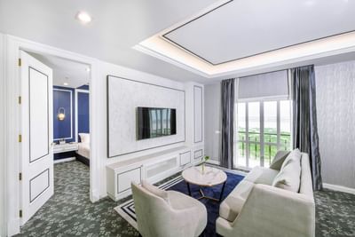 Living area with comfy sofa & coffee table in a Suite at Eastin Hotels