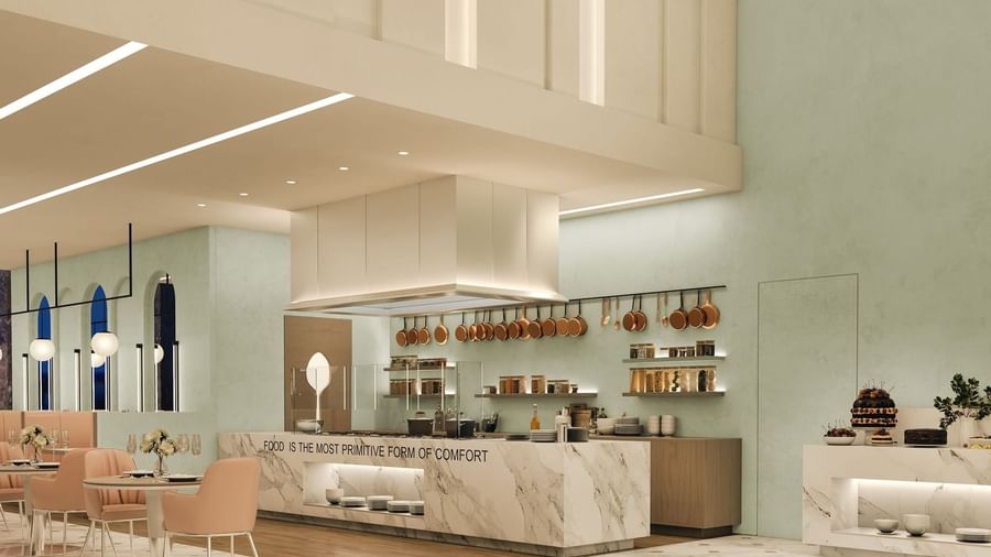 The Med features Copper pans hanging by a marble counter under a large white vent hood at Cantonal Hotel by Warwick Riyadh