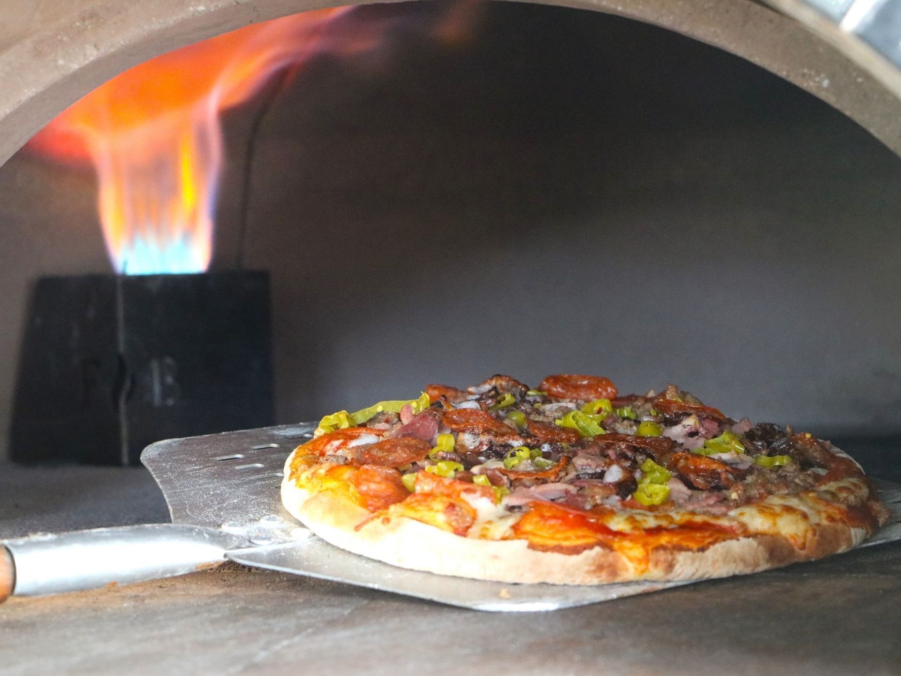 Wood fired oven pizza with a crispy finish from licking flames at Alaia Belize Autograph Collection