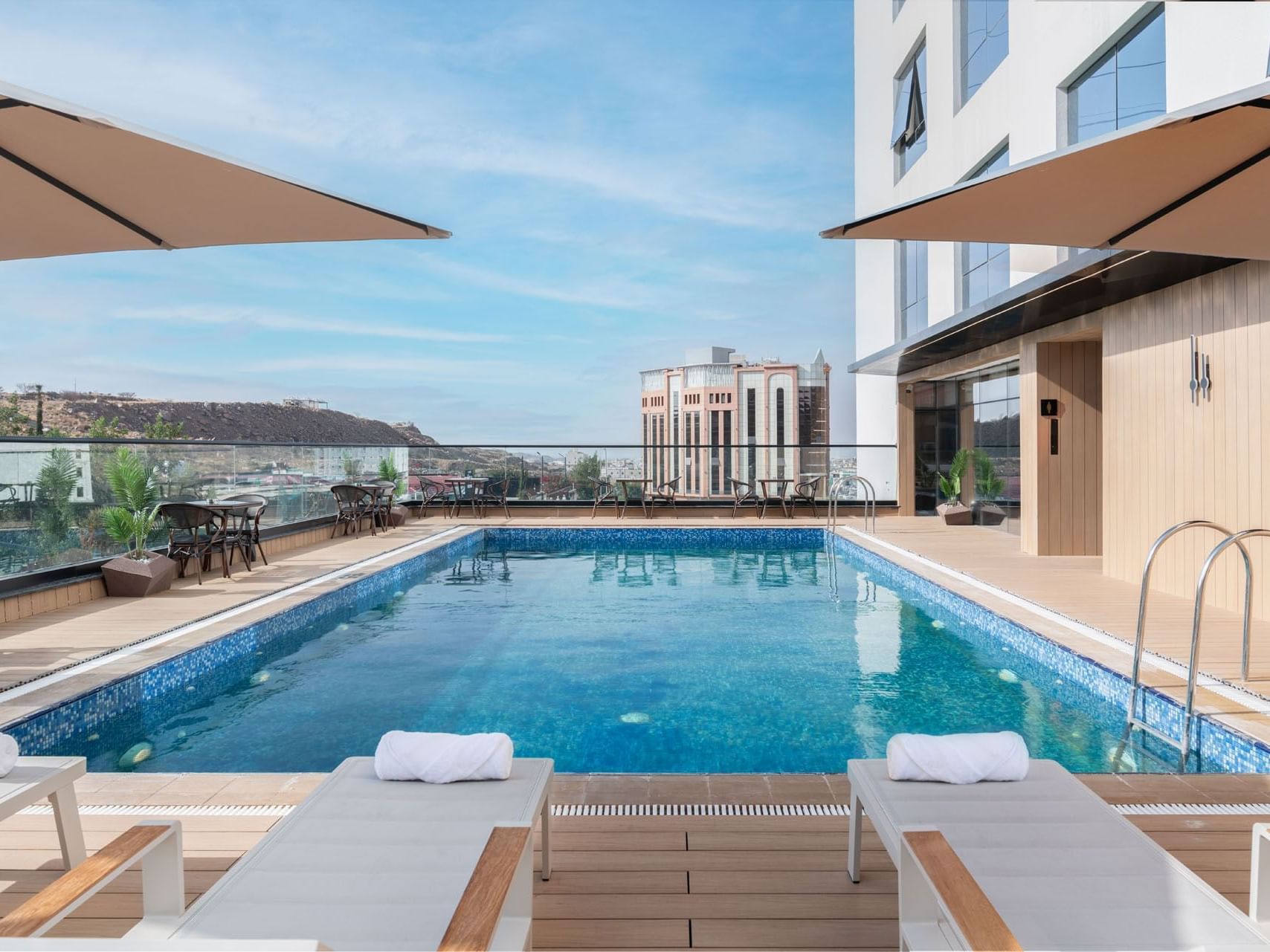 Exterior view of outdoor pool area with sun loungers at Warwick Hotels and Resorts