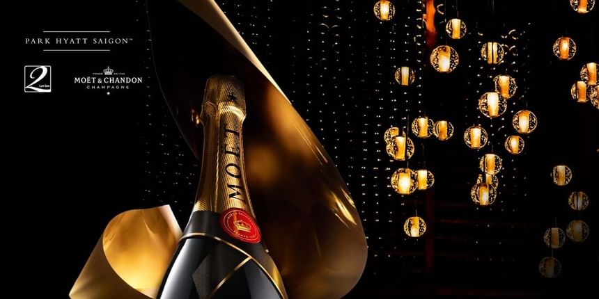 Bottle of Moët & Chandon champagne with a gold label, surrounded by elegant golden lights at Park Hyatt Saigon