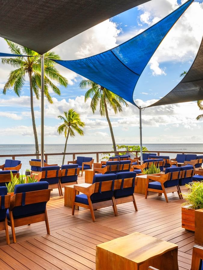 Blue and wooden seating area with ocean view at The Naviti Resort - Fiji, Korolevu.