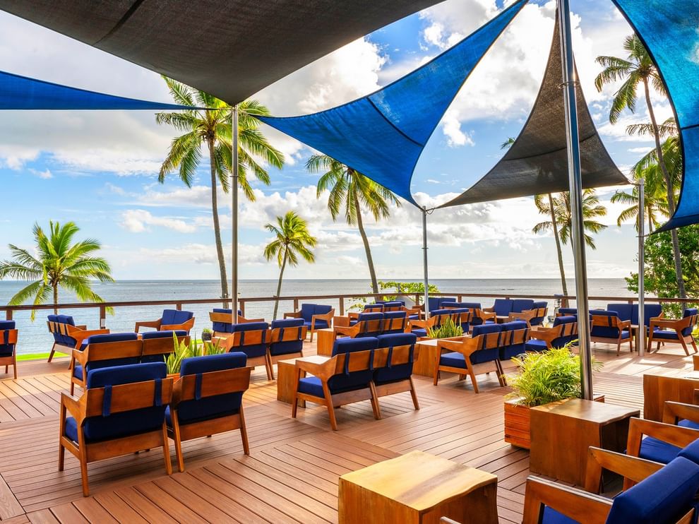 Blue and wooden seating area with ocean view at The Naviti Resort - Fiji, Korolevu.