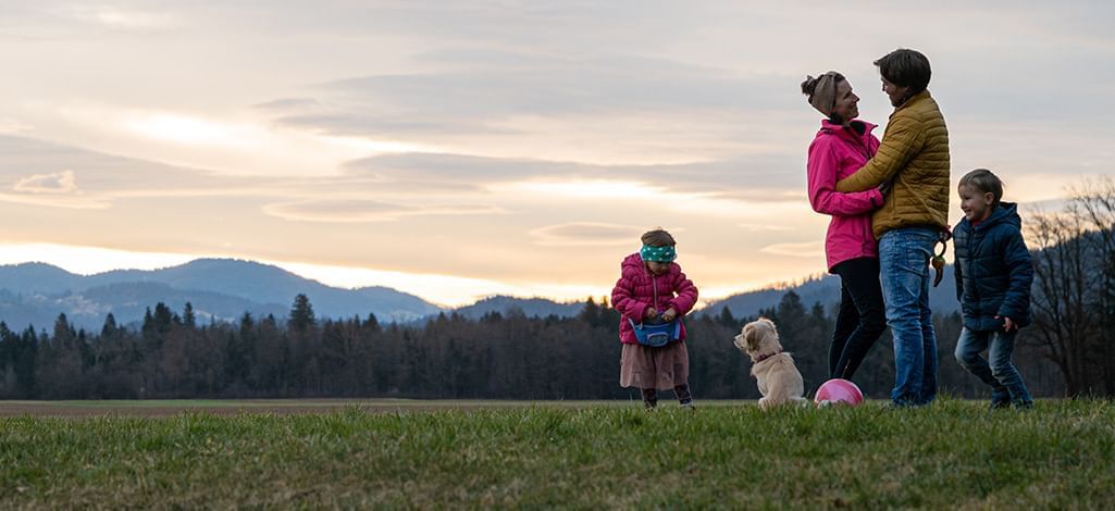 family outside in a green meadow