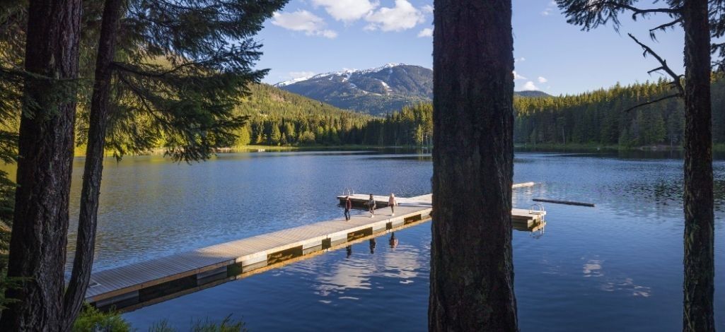 Quiet dock on Lost Lake in Whistler surrounded by forest and mountain views