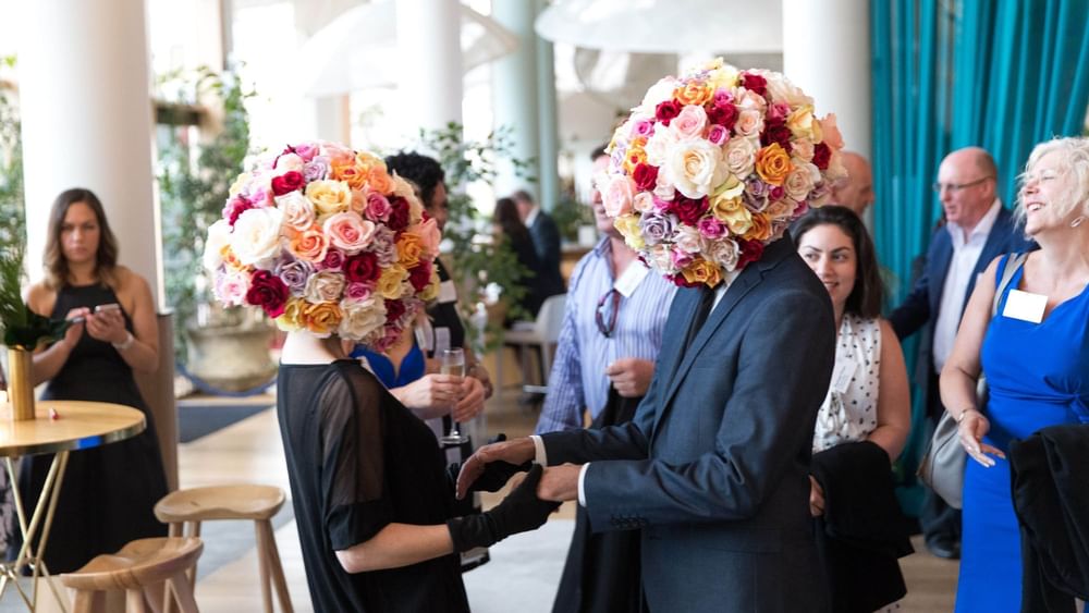 Two people with elaborate floral arrangements as heads at The Ternary in Novotel Sydney on Darling Harbour