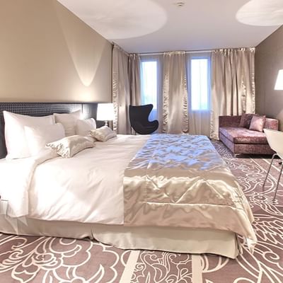 Deluxe Room bed & lounge area at Falkensteiner Hotel Belgrade