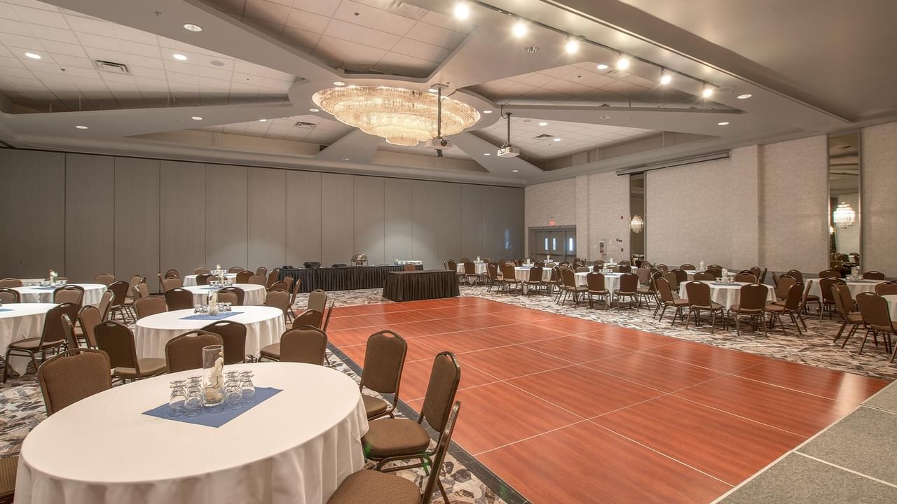 Large ballroom with tables, chairs, and a dance floor.