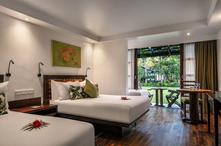 Superior Garden View Rooms feature beds by a patio table under a pergola at Warwick Fiji Resort and Spa