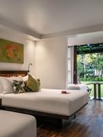 Superior Garden View Rooms feature beds by a patio table under a pergola at Warwick Fiji Resort and Spa
