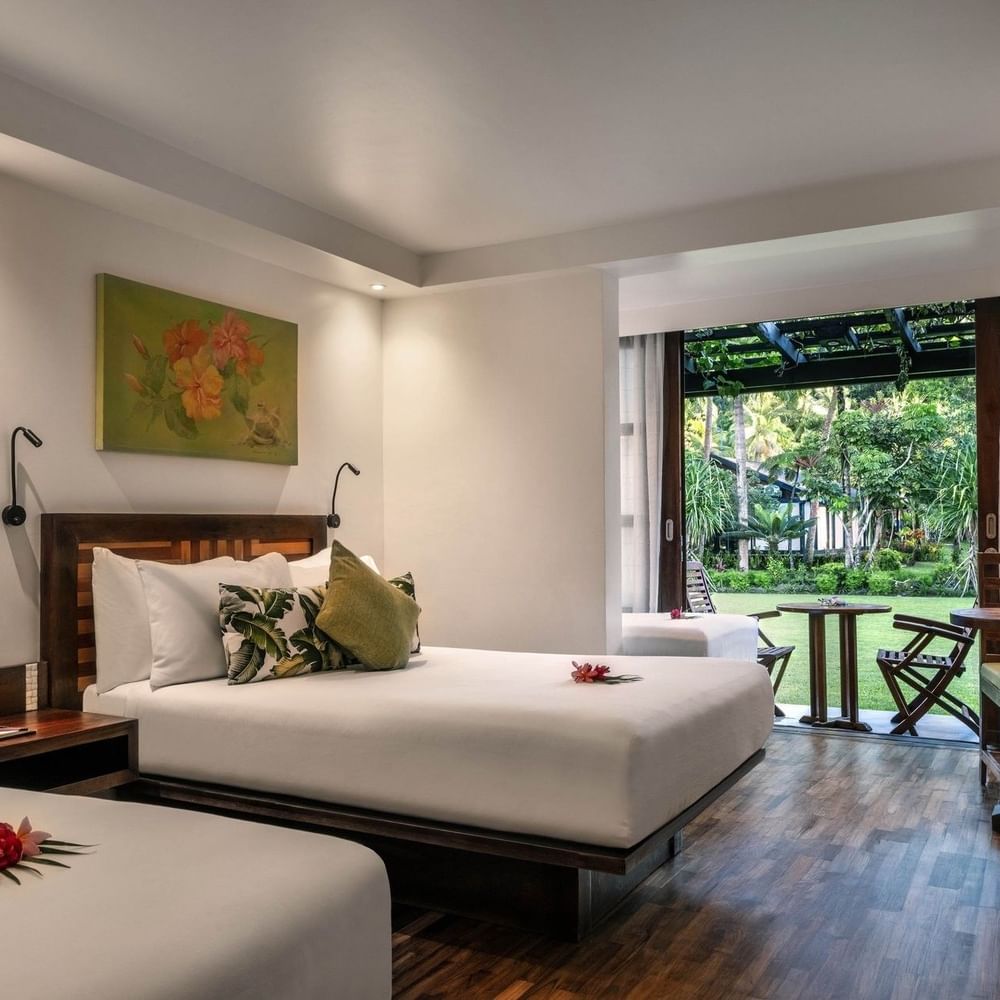 Superior Garden View Rooms feature beds by a patio table under a pergola at Warwick Fiji Resort and Spa