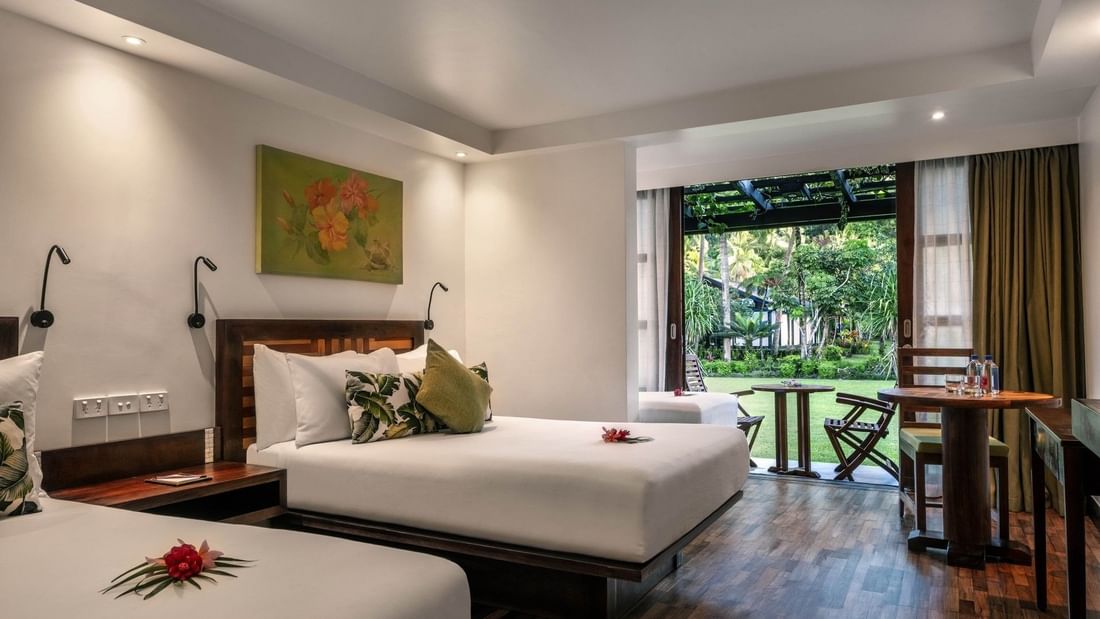 Superior Garden View Rooms feature beds by a patio table under a pergola at Warwick Fiji Resort and Spa