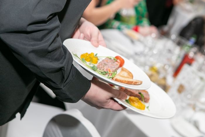 Man holding two plates at The Imperial Hotel Blackpool