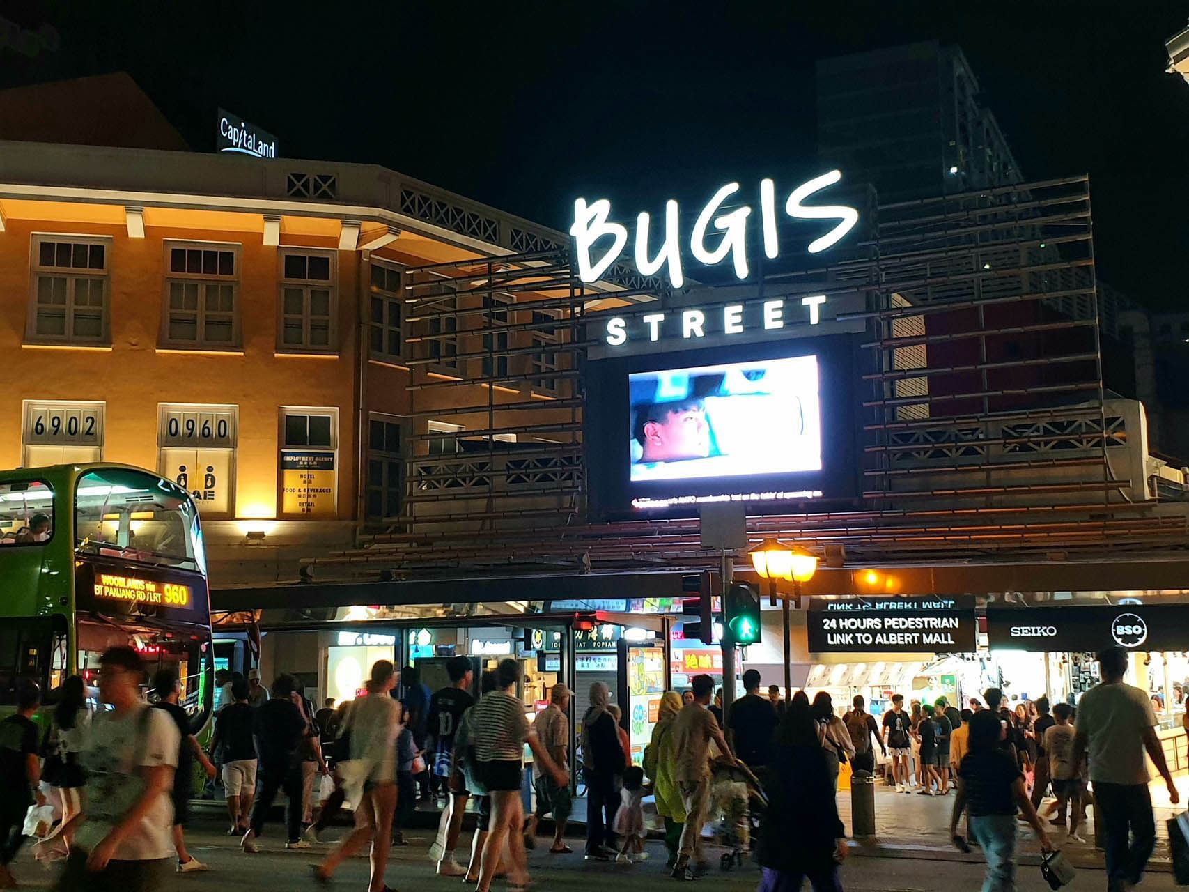Crowded Bugis Street market at night near Nostalgia Hotel Singapore